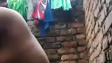 Village Bhabhi bathing nude in open backyard
