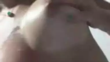 Beautiful girl massaging lovely boobs with lotion